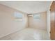 Bright bedroom with neutral paint, tiled floors, two windows and wall air conditioning unit at 7034 N King Arthur E Dr # 4, Port Richey, FL 34668