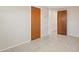 Bedroom features neutral paint, tiled floors and two wood doors at 7034 N King Arthur E Dr # 4, Port Richey, FL 34668