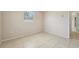 Neutral bedroom featuring tile floors and natural light from the window at 7034 N King Arthur E Dr # 4, Port Richey, FL 34668