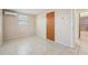 Bright bedroom with neutral paint, tiled floors, one window and wall air conditioning unit at 7034 N King Arthur E Dr # 4, Port Richey, FL 34668