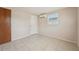 Bright bedroom features tile floors, a window, and a wardrobe closet at 7034 N King Arthur E Dr # 4, Port Richey, FL 34668