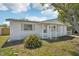Inviting single-story home featuring a charming front porch and well-maintained landscaping at 7034 N King Arthur E Dr # 4, Port Richey, FL 34668