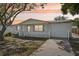 Charming single-story home featuring a well-maintained front yard and inviting curb appeal at sunset at 7034 N King Arthur E Dr # 4, Port Richey, FL 34668