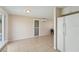 The kitchen area with tile flooring leads into the dining or living area at 7034 N King Arthur E Dr # 4, Port Richey, FL 34668