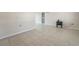 Spacious living room with neutral paint, tiled floors and a sliding door to a rear patio at 7034 N King Arthur E Dr # 4, Port Richey, FL 34668