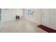 Bright living room featuring neutral paint, tile floors, a front window, and a minimalist design at 7034 N King Arthur E Dr # 4, Port Richey, FL 34668