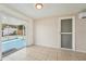 Bright living room with tile floor, screen door to backyard, and air conditioner at 7034 N King Arthur E Dr # 4, Port Richey, FL 34668