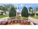 Entrance to a well-maintained Heather Walk community with lush landscaping and mature trees at 7495 Heather Walk Dr, Weeki Wachee, FL 34613