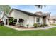 Charming one-story home featuring lush landscaping, mulch beds, and neutral stucco exterior at 7495 Heather Walk Dr, Weeki Wachee, FL 34613