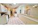Bright kitchen featuring tiled floors, white cabinets, and pass through to living room at 7495 Heather Walk Dr, Weeki Wachee, FL 34613