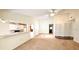 Bright living room featuring neutral carpet, fan, and adjacent kitchen at 7495 Heather Walk Dr, Weeki Wachee, FL 34613