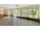 Bright sunroom with tiled floors, ceiling fan, and vertical blinds at 7495 Heather Walk Dr, Weeki Wachee, FL 34613