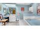 Bright bathroom featuring tub, vanity, neutral tile and light blue walls at 8200 Rhanbuoy Rd, Spring Hill, FL 34606