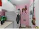Well-lit laundry room features a modern washer and dryer and ample cabinet space at 8200 Rhanbuoy Rd, Spring Hill, FL 34606