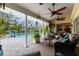 Covered patio with ceiling fans and comfortable seating, ideal for outdoor entertaining and relaxation near the pool area at 8200 Rhanbuoy Rd, Spring Hill, FL 34606