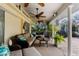 Inviting covered patio with ceiling fans and cozy furniture, perfect for outdoor lounging and entertaining near the pool at 8200 Rhanbuoy Rd, Spring Hill, FL 34606