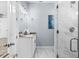 Bathroom features white cabinets, granite counter and walk-in shower with glass door at 8312 40Th N St, Pinellas Park, FL 33781
