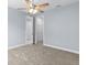 Bedroom features a ceiling fan and leads to a walk-in closet at 8312 40Th N St, Pinellas Park, FL 33781