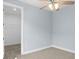 Bright bedroom features neutral carpet, ceiling fan, walk-in closet, and light-blue painted walls at 8312 40Th N St, Pinellas Park, FL 33781