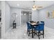 Bright dining room with a modern table and chairs, ceiling fan, and marble floors at 8312 40Th N St, Pinellas Park, FL 33781