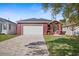 Charming single-story home featuring a brick driveway and a two-car garage at 8312 40Th N St, Pinellas Park, FL 33781