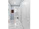 Hallway with marble floors leads to bathroom with tub at 8312 40Th N St, Pinellas Park, FL 33781