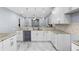 Modern kitchen features white cabinets, stone counters and stainless steel appliances at 8312 40Th N St, Pinellas Park, FL 33781