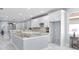 Modern kitchen features white cabinets, stone counters and stainless steel appliances at 8312 40Th N St, Pinellas Park, FL 33781