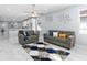 Bright living room features tile floors, ceiling fan, and modern decor accents at 8312 40Th N St, Pinellas Park, FL 33781