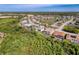 A sprawling community features lush greenery and well-maintained homes, some with pools, in a vibrant neighborhood setting at 8606 Coral Creek Loop, Hudson, FL 34667