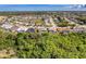 A sprawling community features lush greenery and well-maintained homes, some with pools, in a vibrant neighborhood setting at 8606 Coral Creek Loop, Hudson, FL 34667