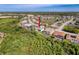 Wide aerial view of residential neighborhood surrounded by green spaces at 8606 Coral Creek Loop, Hudson, FL 34667