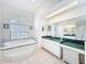 A well-lit bathroom showcasing a large soaking tub and dual vanity sinks with ample counter space at 8606 Coral Creek Loop, Hudson, FL 34667