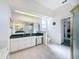 Bright bathroom featuring a glass-enclosed shower, white cabinetry, and a green countertop at 8606 Coral Creek Loop, Hudson, FL 34667