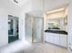 Bright bathroom featuring a glass-enclosed shower, white cabinetry, and a green countertop at 8606 Coral Creek Loop, Hudson, FL 34667