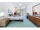 Primary bedroom with a ceiling fan, access to a balcony, and lots of natural light at 8606 Coral Creek Loop, Hudson, FL 34667