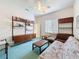 Bedroom featuring carpeted floors, natural light, and shelving, creating a cozy retreat at 8606 Coral Creek Loop, Hudson, FL 34667