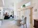 Open-concept dining area with a glass table, chandelier, and views into the living space at 8606 Coral Creek Loop, Hudson, FL 34667