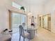 A bright dining area with a glass table set, sliding glass doors, and natural light at 8606 Coral Creek Loop, Hudson, FL 34667