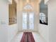 Elegant entrance featuring frosted double doors, tile flooring, and decorative transom window at 8606 Coral Creek Loop, Hudson, FL 34667
