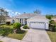 Charming single-story home with manicured front yard and two-car garage at 8606 Coral Creek Loop, Hudson, FL 34667