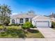 Charming single-story home with manicured front yard and two-car garage at 8606 Coral Creek Loop, Hudson, FL 34667