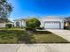 Charming single-story home with manicured front yard and two-car garage at 8606 Coral Creek Loop, Hudson, FL 34667