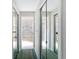 Hallway showcasing a mirror closet leading to a luxurious bathroom with a soaking tub at 8606 Coral Creek Loop, Hudson, FL 34667