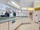 Bright kitchen with a breakfast bar that flows into the living area with high ceilings at 8606 Coral Creek Loop, Hudson, FL 34667