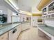 Bright kitchen with white cabinets, countertops, and tile flooring at 8606 Coral Creek Loop, Hudson, FL 34667