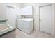 Functional laundry room with a washer, dryer, overhead storage, and a sink at 8606 Coral Creek Loop, Hudson, FL 34667