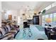 Large living room with tall ceilings, ceiling fan, and a fireplace with built in bar at 8606 Coral Creek Loop, Hudson, FL 34667