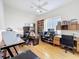 Spacious office with a ceiling fan, natural light, and hardwood floors at 8606 Coral Creek Loop, Hudson, FL 34667