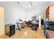 Well lit office features wood flooring, bookshelves, ceiling fan, and multiple monitors, creating an ideal work-from-home environment at 8606 Coral Creek Loop, Hudson, FL 34667